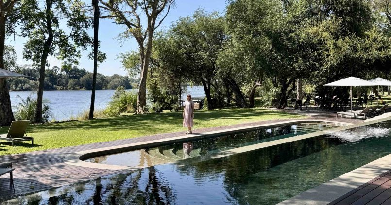 Serene pool area at The Palm River Hotel with views of the Zambezi River